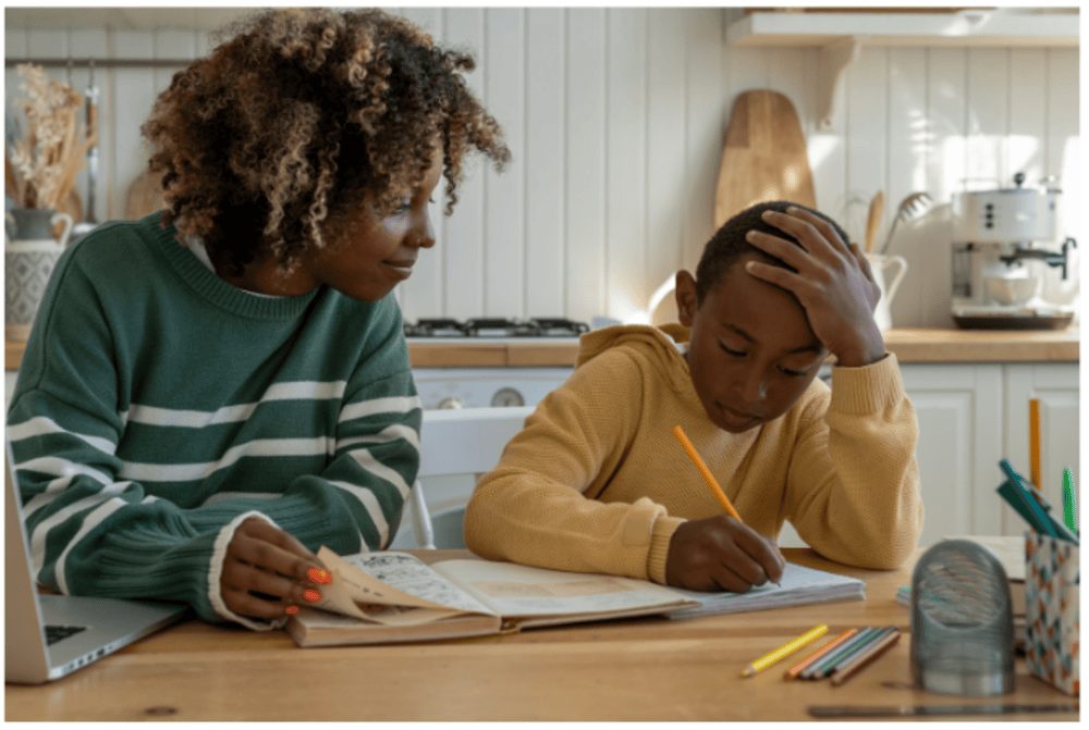 mother is teaching son on Kitchen table